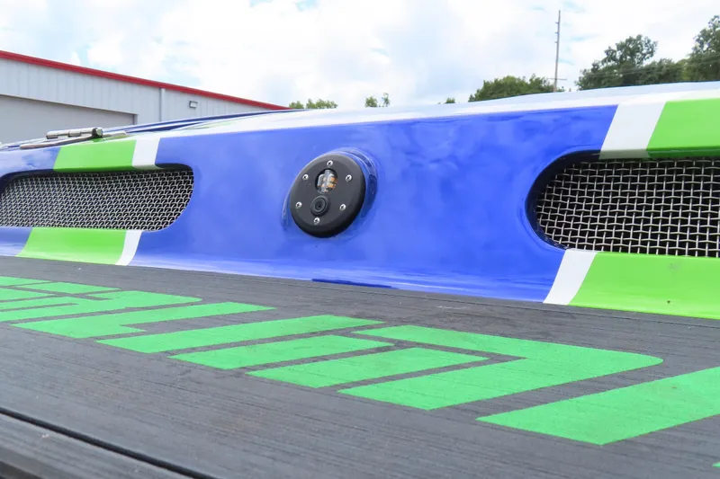 Slide: The Image of 2007 Outerlimits 44 GTX boat detail with vibrant blue and green accents. - 7