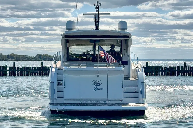 Slide: The Image of 2016 Sunseeker Predator 57 yacht on water, rear view with American flag. - 11