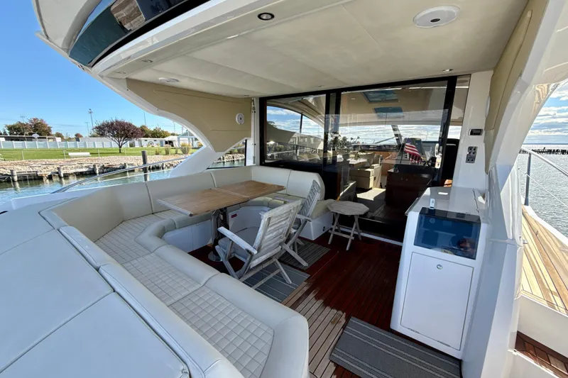 Slide: The Image of Luxurious 2016 Sunseeker Predator 57 yacht with elegant outdoor seating and dining area. - 12