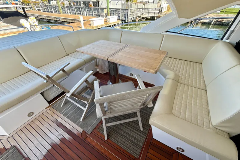 Slide: The Image of Luxurious seating area on 2016 Sunseeker Predator 57 yacht with wooden table and chairs. - 14