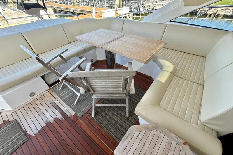 Slide: The Image of Luxurious seating area on 2016 Sunseeker Predator 57 yacht with wooden table and chairs. - 15