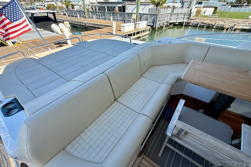 Slide: The Image of Luxurious seating area on a 2016 Sunseeker Predator 57 yacht with American flag. - 16