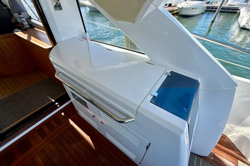 Slide: The Image of Sunseeker Predator 57 yacht interior, 2016 model, featuring sleek white cabinetry and wooden flooring. - 17