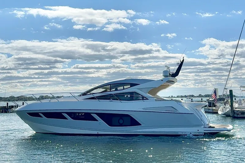 Slide: The Image of 2016 Sunseeker Predator 57 yacht on water under a partly cloudy sky. - 4
