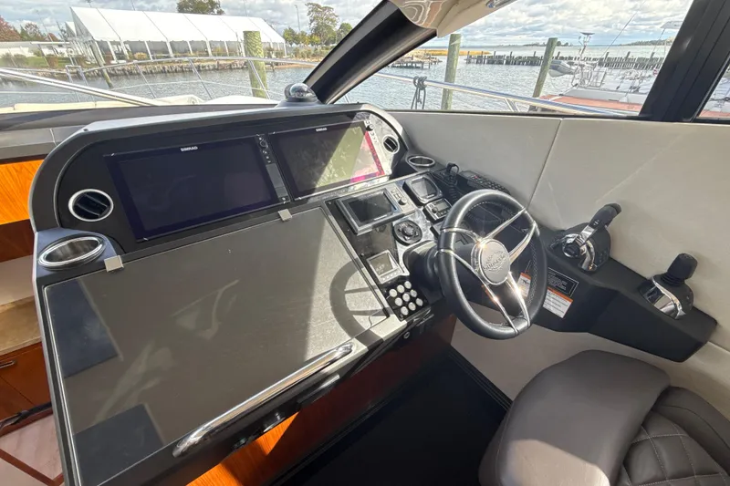 Slide: The Image of Helm of 2016 Sunseeker Predator 57 yacht with modern navigation controls and steering wheel. - 41
