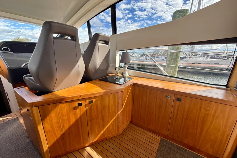 Slide: The Image of Interior of 2016 Sunseeker Predator 57 yacht with wooden cabinetry and large windows. - 44