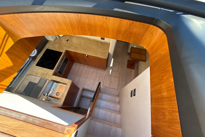 Slide: The Image of Interior view of 2016 Sunseeker Predator 57 yacht, featuring modern kitchen and wooden finishes. - 47