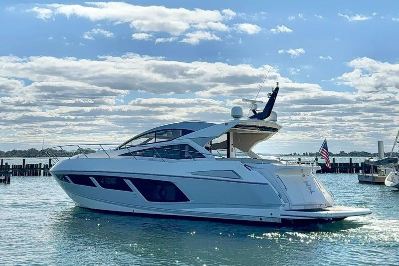 Slide: The Image of 2016 Sunseeker Predator 57 yacht on water under a partly cloudy sky. - 6