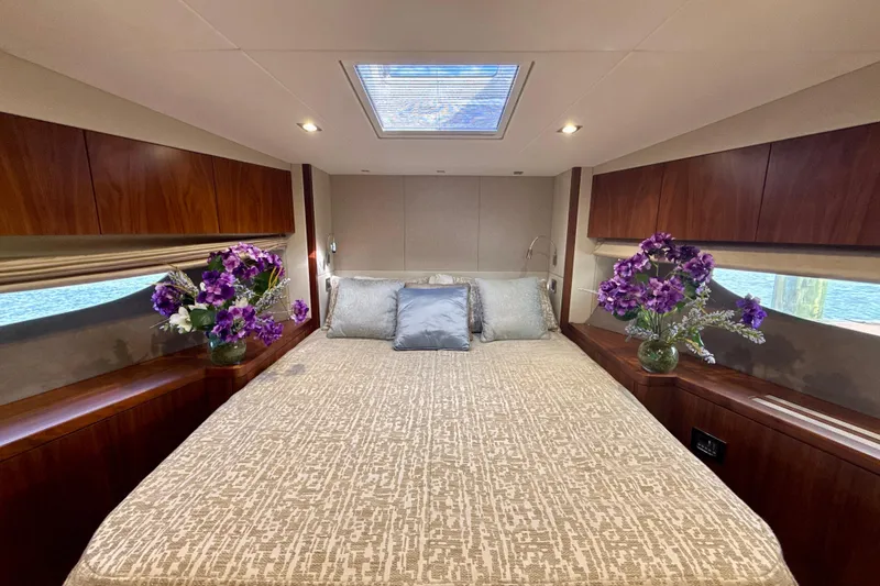 Slide: The Image of Luxurious 2016 Sunseeker Predator 57 yacht bedroom with elegant decor and floral arrangements. - 62