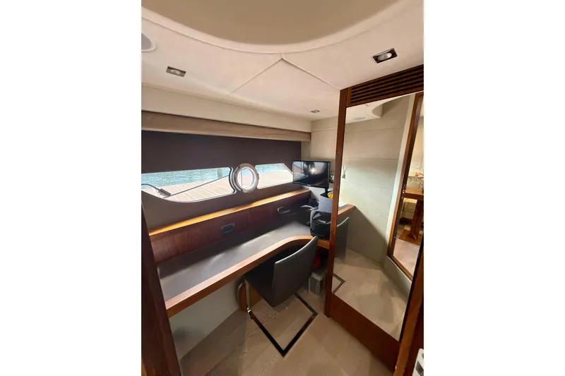 Slide: The Image of Interior of 2016 Sunseeker Predator 57 yacht with desk, chair, and window view. - 65