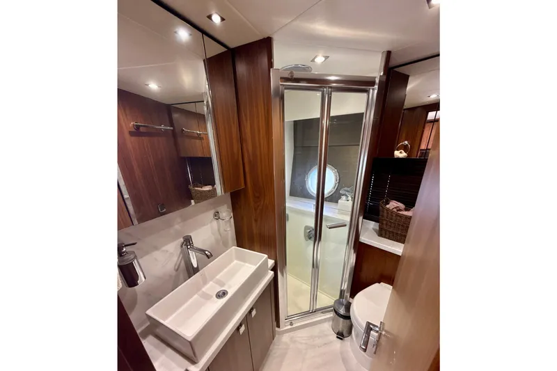 Slide: The Image of Luxurious bathroom in 2016 Sunseeker Predator 57 yacht with modern fixtures and wood accents. - 66