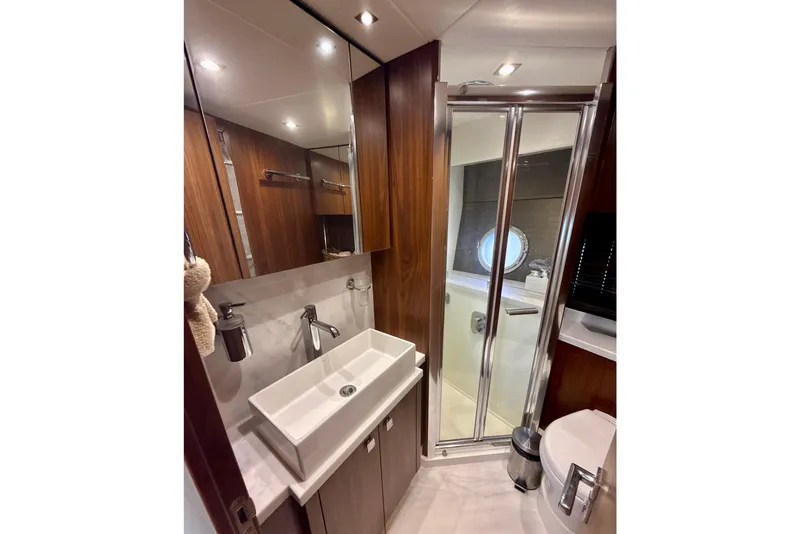Slide: The Image of Luxurious bathroom in 2016 Sunseeker Predator 57 yacht with modern fixtures and wood accents. - 67