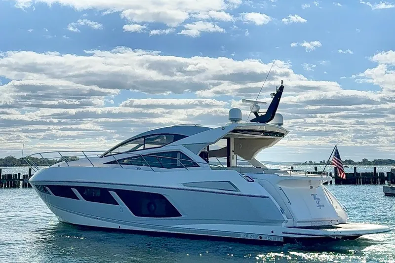 Slide: The Image of 2016 Sunseeker Predator 57 yacht on water under a partly cloudy sky. - 7