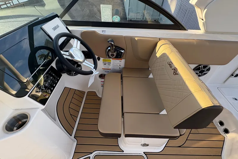 Slide: The Image of 2026 Sea Ray SDX 230 Outboard boat interior with steering wheel and seating. - 4