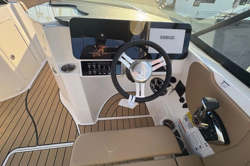 Slide: The Image of 2026 Sea Ray SDX 230 Outboard helm with Simrad display and modern controls. - 5