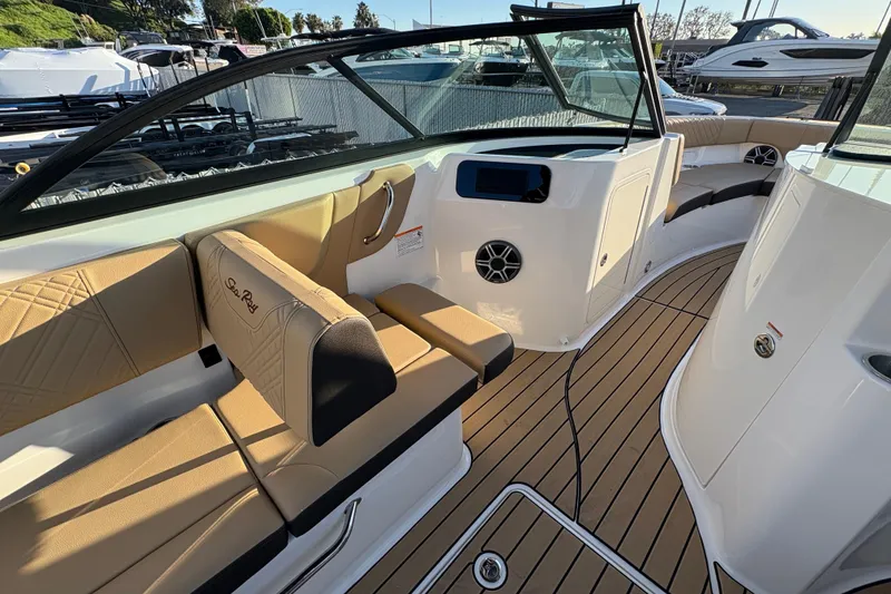 Slide: The Image of 2026 Sea Ray SDX 230 Outboard boat interior with tan seating and sleek design. - 6
