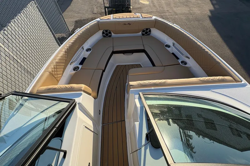 Slide: The Image of 2026 Sea Ray SDX 230 Outboard boat interior with tan seating and wood accents. - 7