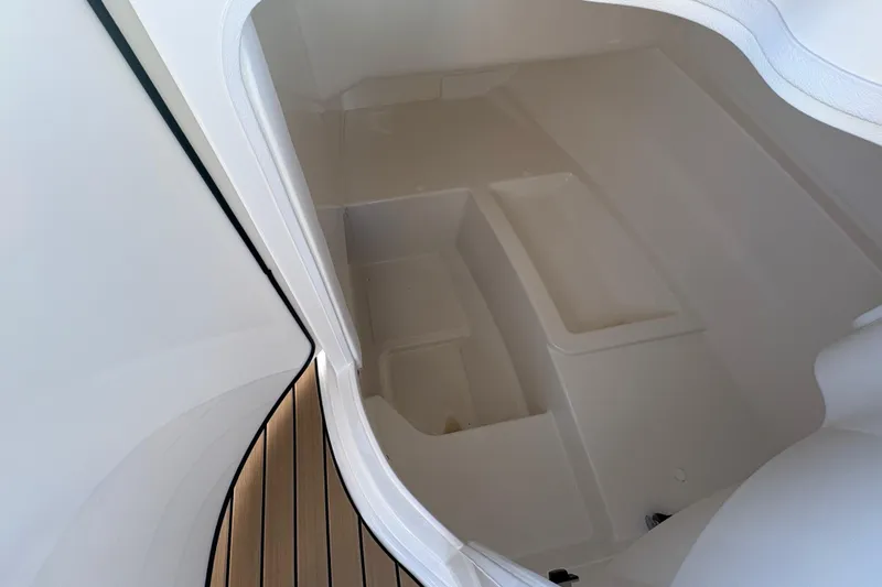 Slide: The Image of 2026 Sea Ray SDX 230 Outboard interior storage compartment, featuring sleek design and ample space. - 8