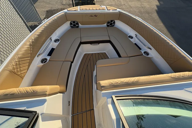 Slide: The Image of Luxurious 2026 Sea Ray SDX 230 Outboard boat interior with tan seating and wood accents. - 9