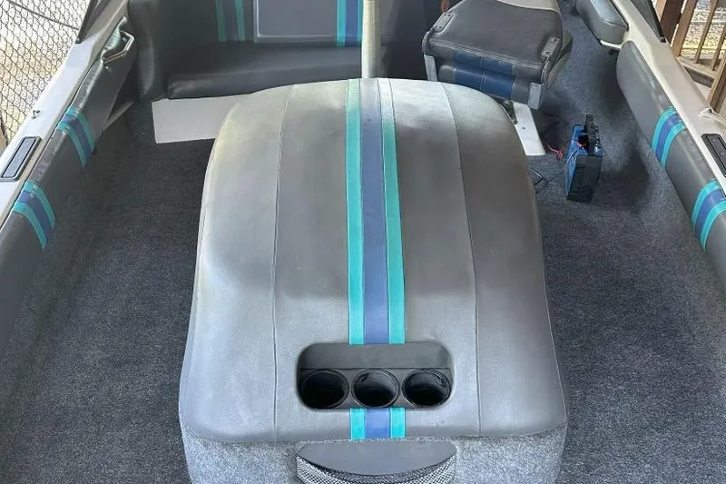 Slide: The Image of Interior of a 1998 Malibu Response boat with gray and teal upholstery. - 13