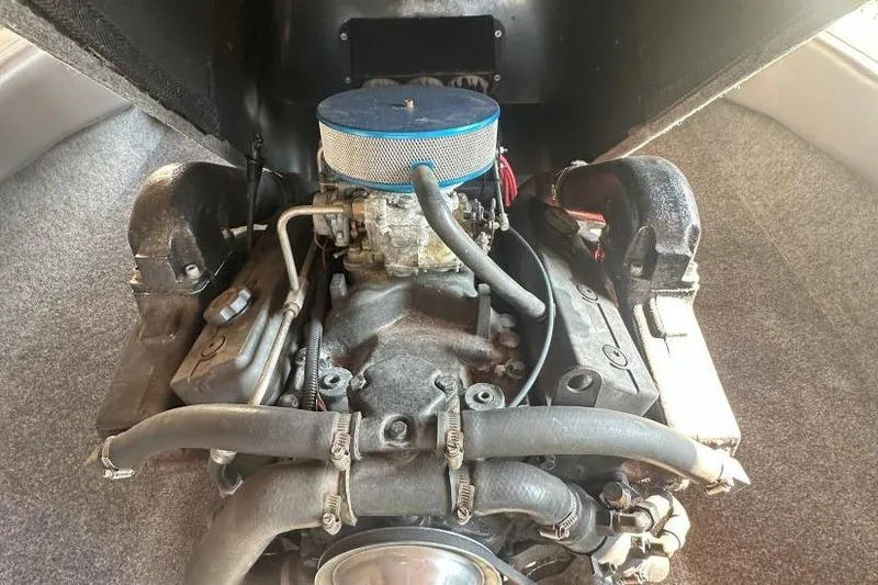 Slide: The Image of 1998 Malibu Response engine compartment with visible air filter and hoses. - 14