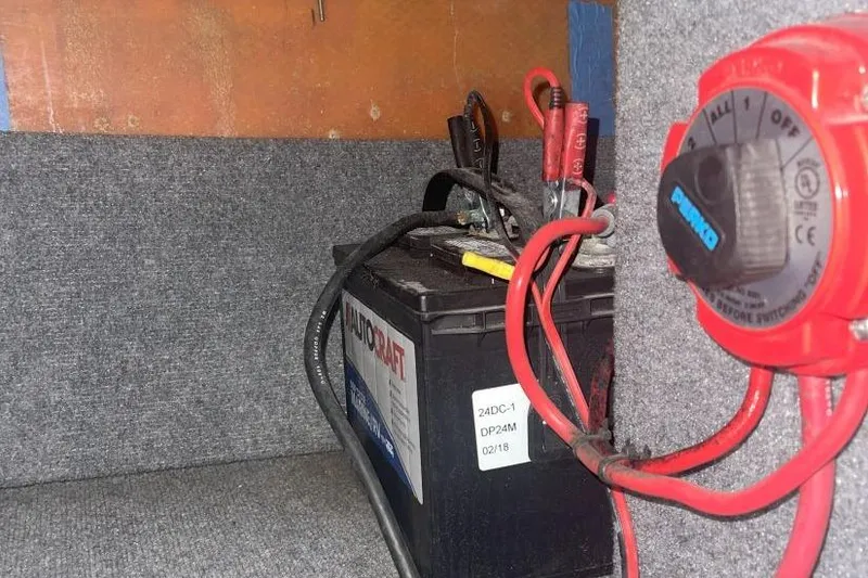 Slide: The Image of Battery setup in a 1998 Malibu Response boat with wiring and switch. - 16