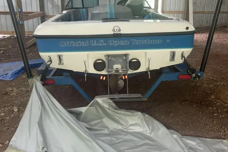 Slide: The Image of 1998 Malibu Response boat, labeled "Official U.S. Open Towboat," stored indoors on a trailer. - 17