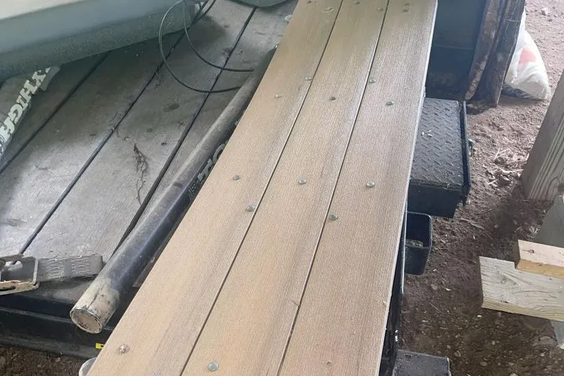 Slide: The Image of Wooden boat trailer for 1998 Malibu Response, parked on dirt ground. - 18