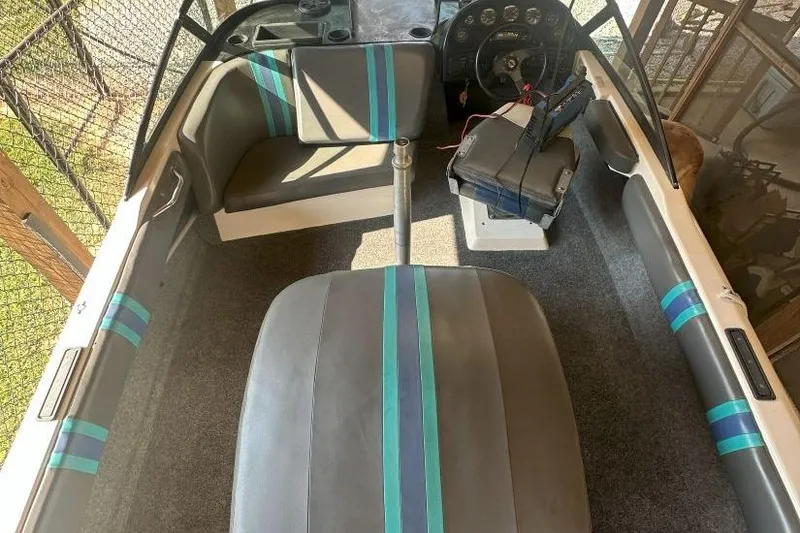 Slide: The Image of 1998 Malibu Response boat interior with striped seating and steering wheel. - 2