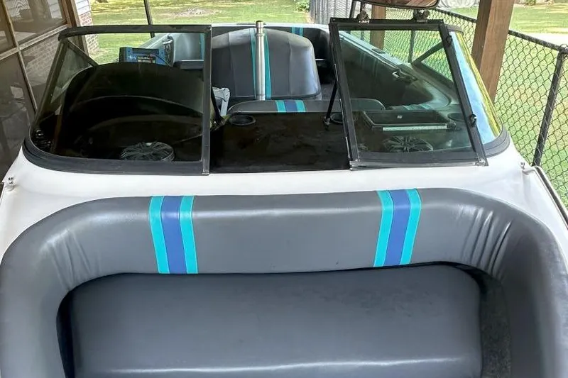 Slide: The Image of 1998 Malibu Response boat interior with blue-striped seats and windshield. - 4