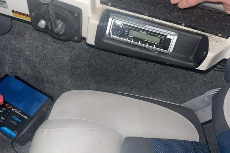 Slide: The Image of 1998 Malibu Response interior with Kenwood stereo and battery charger on carpeted floor. - 6