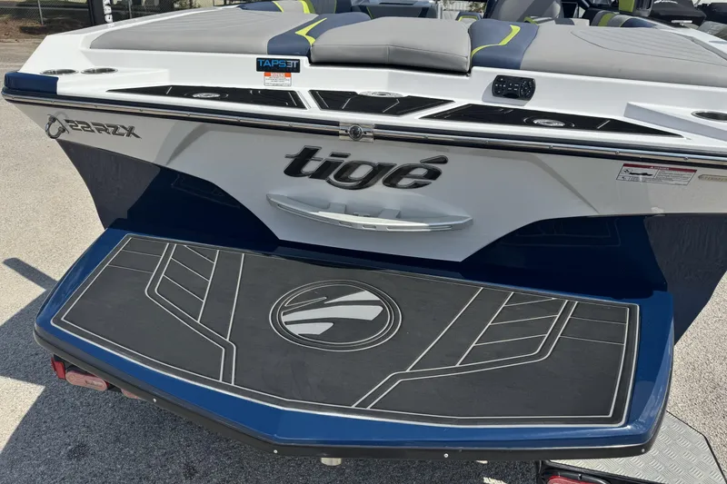 Slide: The Image of 2020 Tigé 22RZX boat rear view with logo and swim platform. - 3