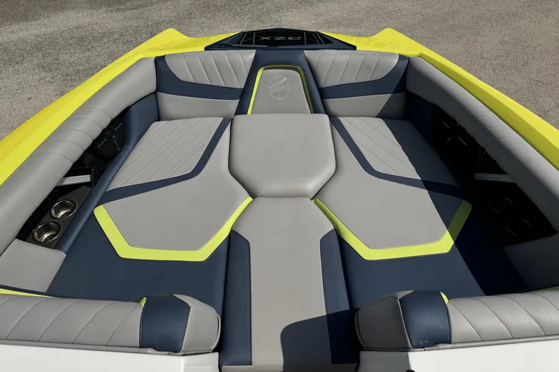 Slide: The Image of 2020 Tigé 22RZX boat interior with gray and blue seating, yellow accents. - 6