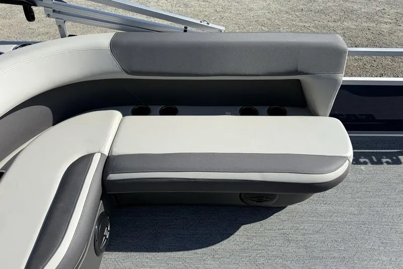 Slide: The Image of 2026 Sun Tracker Bass Buggy 16 XL Select boat seating with cup holders and gray upholstery. - 13