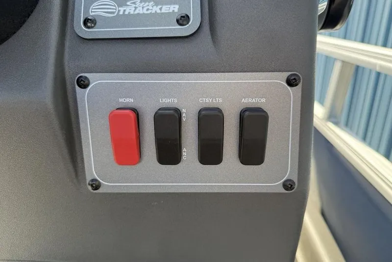 Slide: The Image of Control panel of 2026 Sun Tracker Bass Buggy 16 XL Select with switches for horn, lights, and aerator. - 14