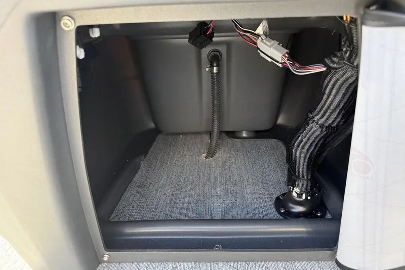 Slide: The Image of Interior view of 2026 Sun Tracker Bass Buggy 16 XL Select, showcasing wiring and storage compartment. - 15
