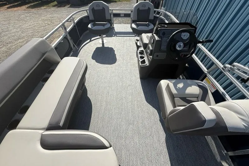 Slide: The Image of 2026 Sun Tracker Bass Buggy 16 XL Select pontoon boat interior with seating and steering console. - 20