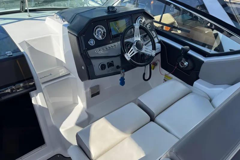 Slide: The Image of 2020 Four Winns Vista 275 boat cockpit with steering wheel and control panel. - 10