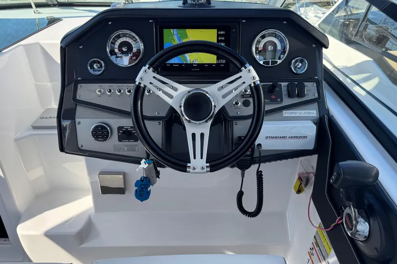 Slide: The Image of 2020 Four Winns Vista 275 dashboard with steering wheel and navigation controls. - 11