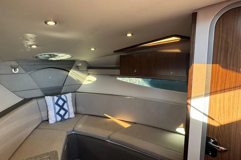 Slide: The Image of 2020 Four Winns Vista 275 cabin interior with modern design and cozy seating. - 15