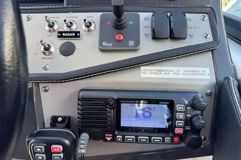 Slide: The Image of Control panel of 2020 Four Winns Vista 275 boat with radio and switches. - 19