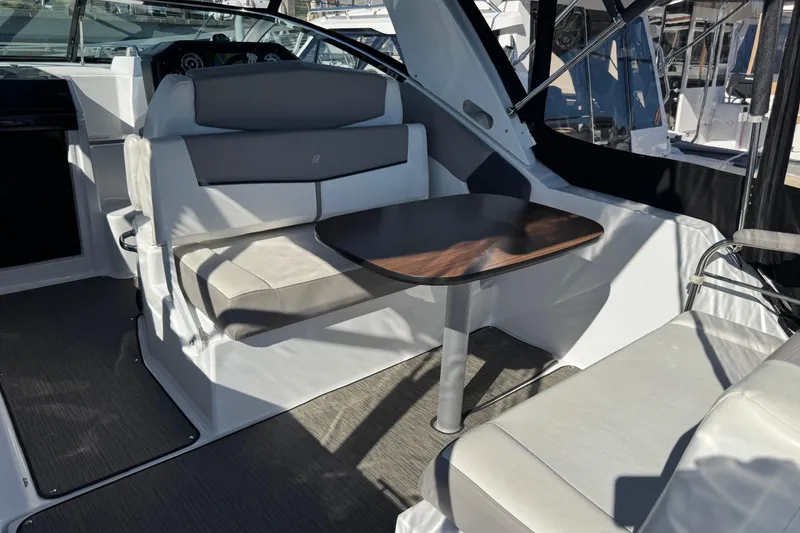 Slide: The Image of 2020 Four Winns Vista 275 interior with seating and table, showcasing modern design. - 7