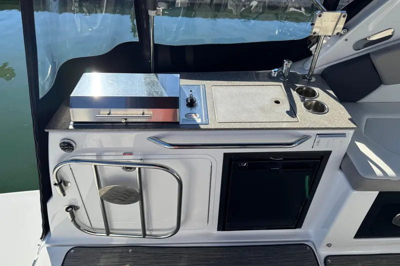 Slide: The Image of 2020 Four Winns Vista 275 boat kitchenette with grill, sink, and storage. - 8