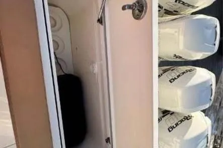 Slide: The Image of 2019 Scout 420 LXF boat with open storage compartment and multiple outboard engines. - 17