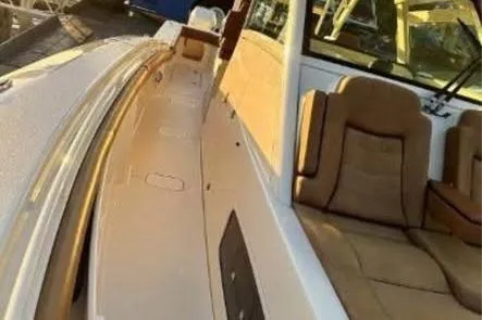 Slide: The Image of 2019 Scout 420 LXF luxury boat interior with tan seating and sleek design. - 26
