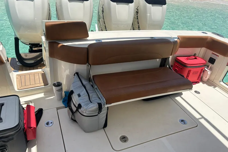 Slide: The Image of 2019 Scout 420 LXF boat interior with seating and coolers on deck. - 30