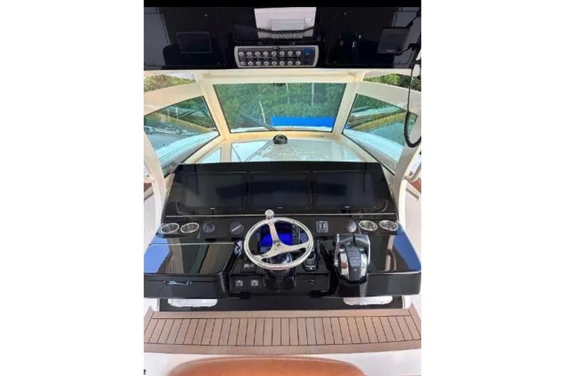 Slide: The Image of 2019 Scout 420 LXF boat helm with steering wheel and control panel. - 35