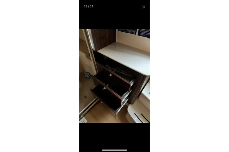 Slide: The Image of Interior of 2019 Scout 420 LXF boat with open storage drawers. - 37