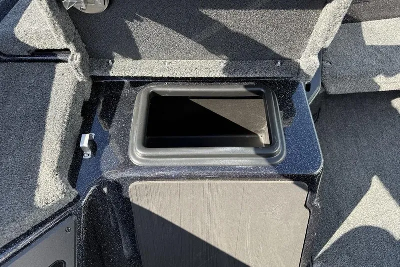 Slide: The Image of 2026 Skeeter ZXR20 SE boat storage compartment with carpeted interior. - 13