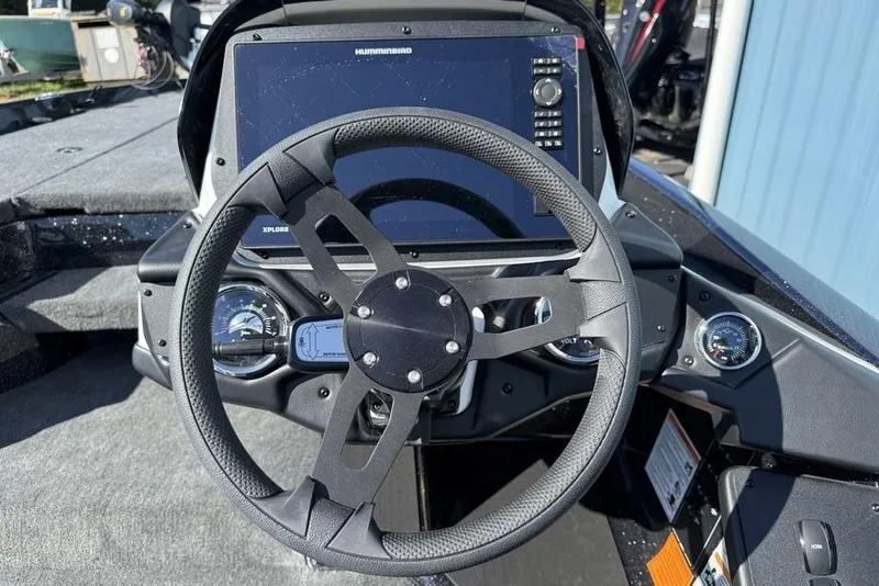 Slide: The Image of Steering wheel and dashboard of 2026 Skeeter ZXR20 SE boat with digital display. - 14